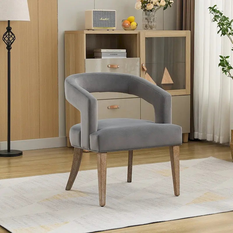 Fauteuil d’appoint rembourré, dossier ouvert et forme tonneau