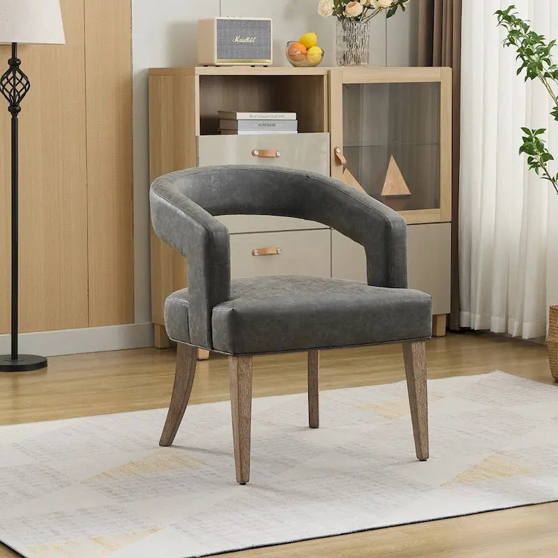 Fauteuil d’appoint rembourré, dossier ouvert et forme tonneau