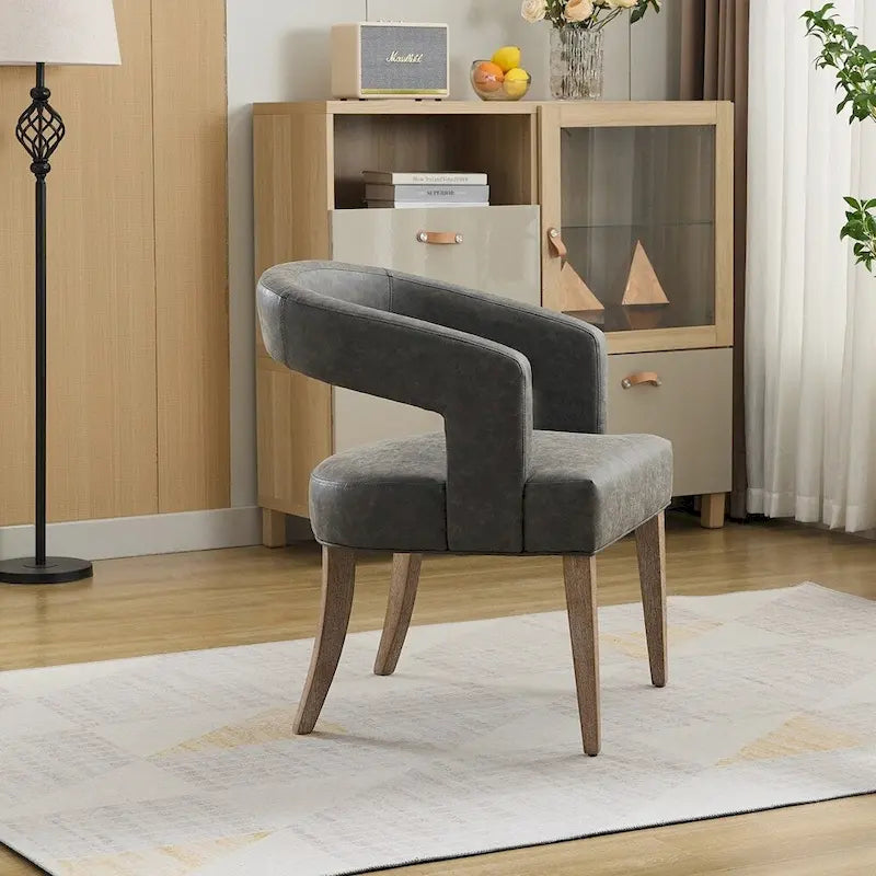 Fauteuil d’appoint rembourré, dossier ouvert et forme tonneau