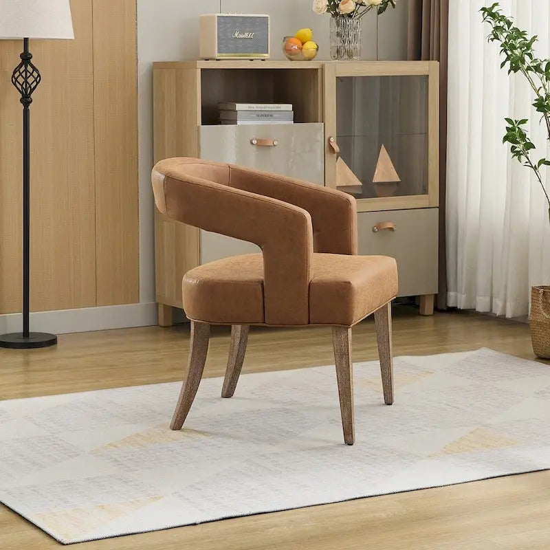 Fauteuil d’appoint rembourré, dossier ouvert et forme tonneau